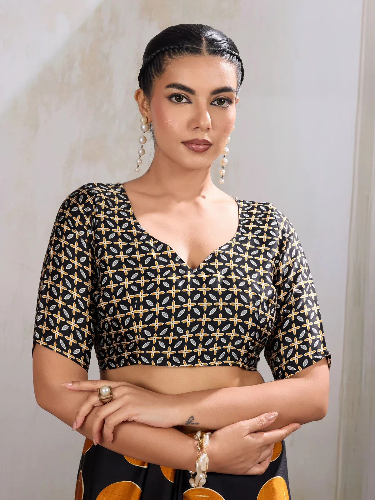 Tarani designer blouse close-up with geometric print and modern neckline in black and gold