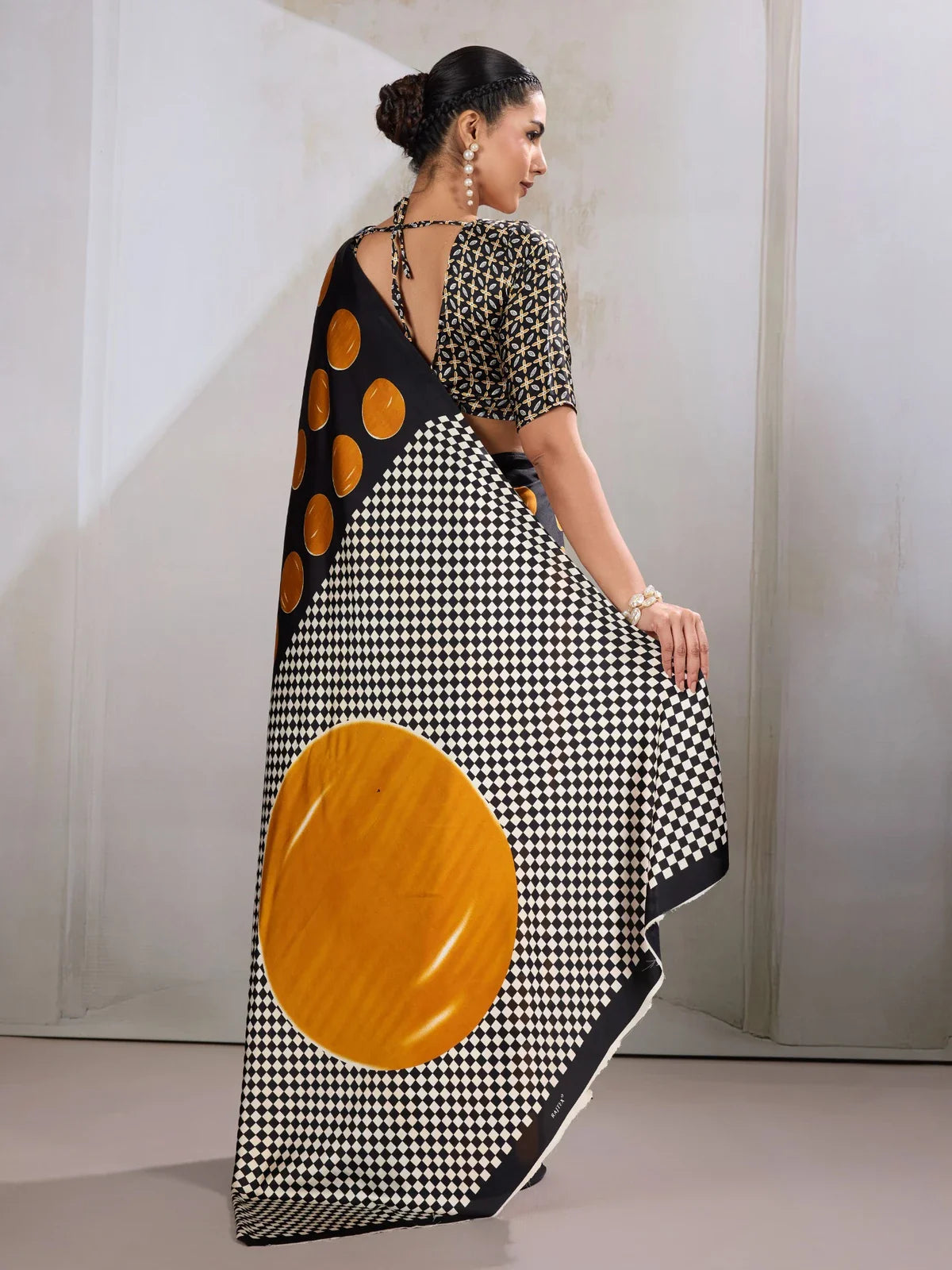 Tarani modal satin saree back view showing large golden motif and checkered pallu design