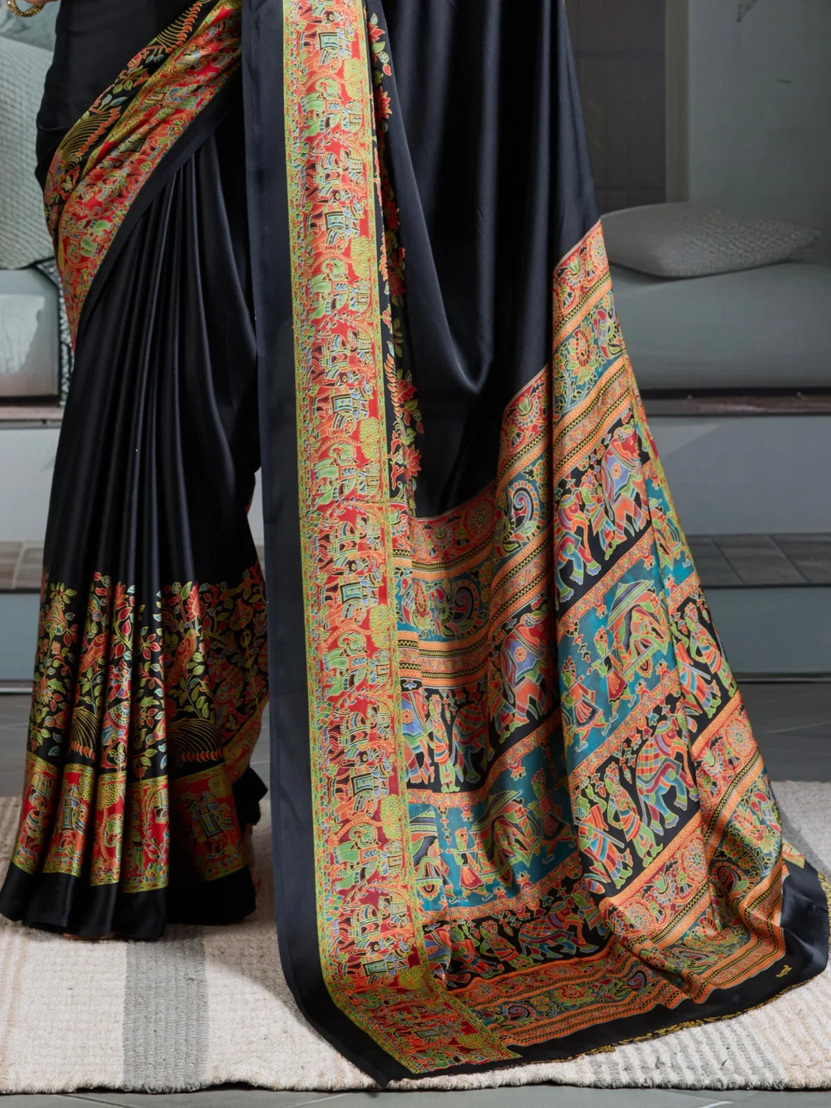 Tarani black saree with traditional multicolor ajrakh pallu captured in close-up view