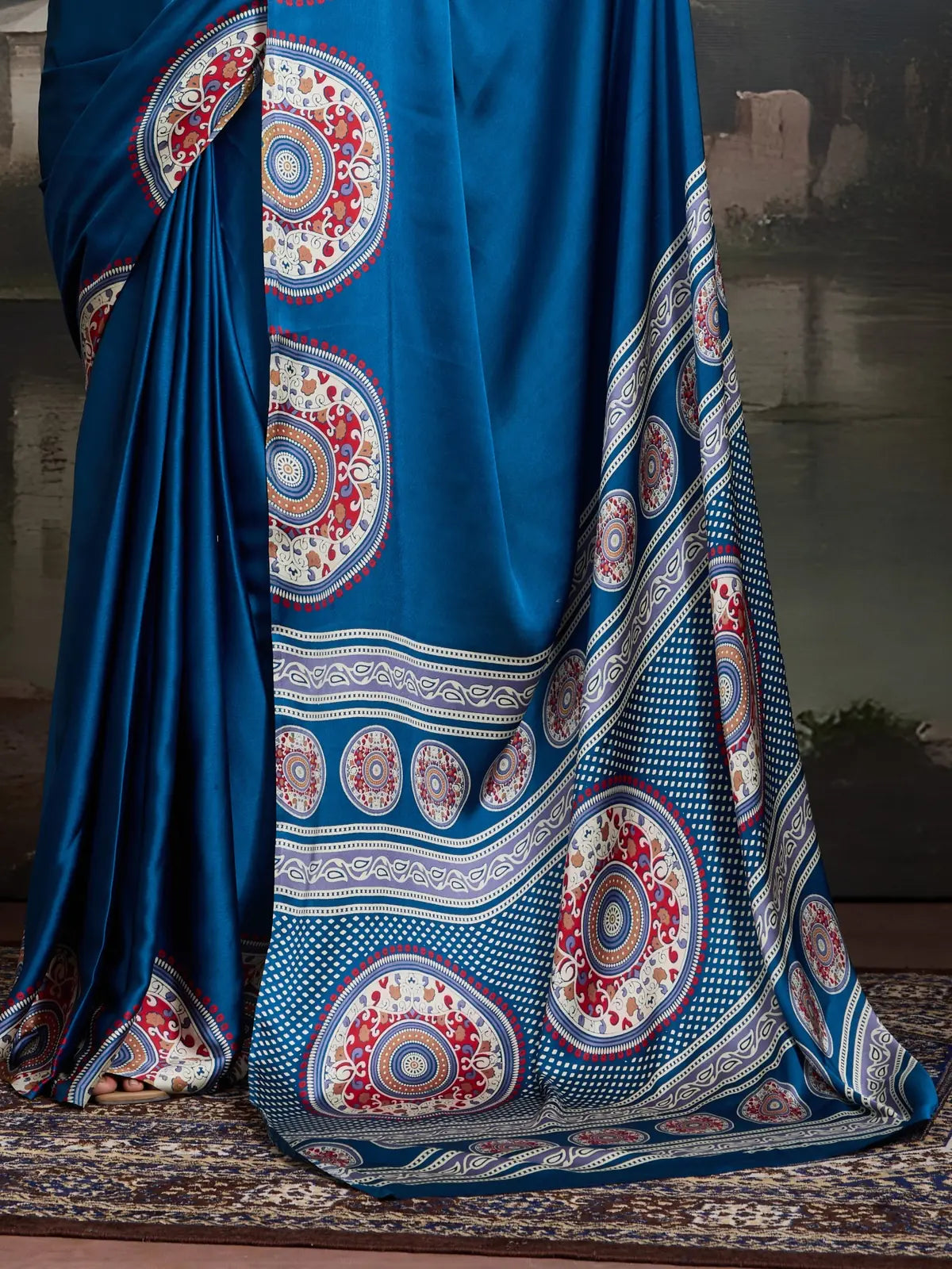 Tarani saree pallu showing bold circular motifs and rich print border in blue modal satin