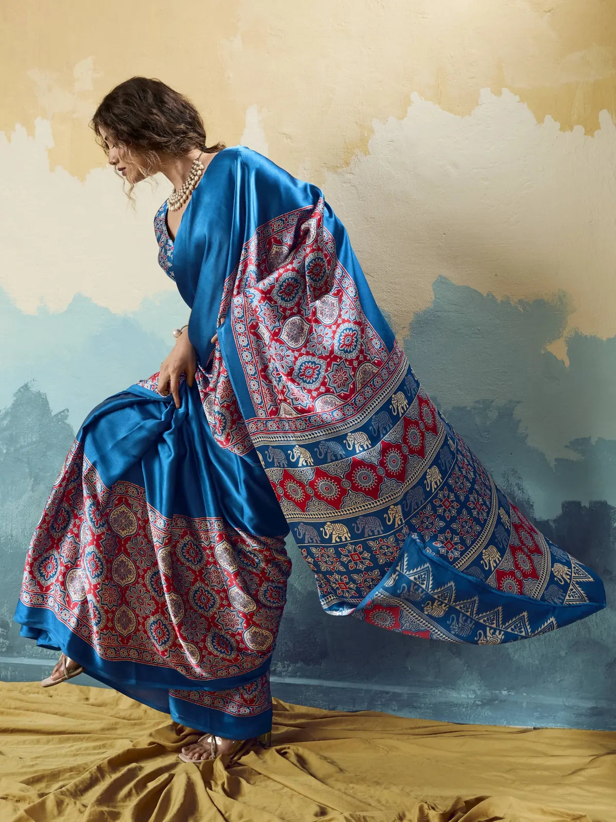 Tarani blue modal satin Ajrakh print saree side view highlighting elegant pallu movement