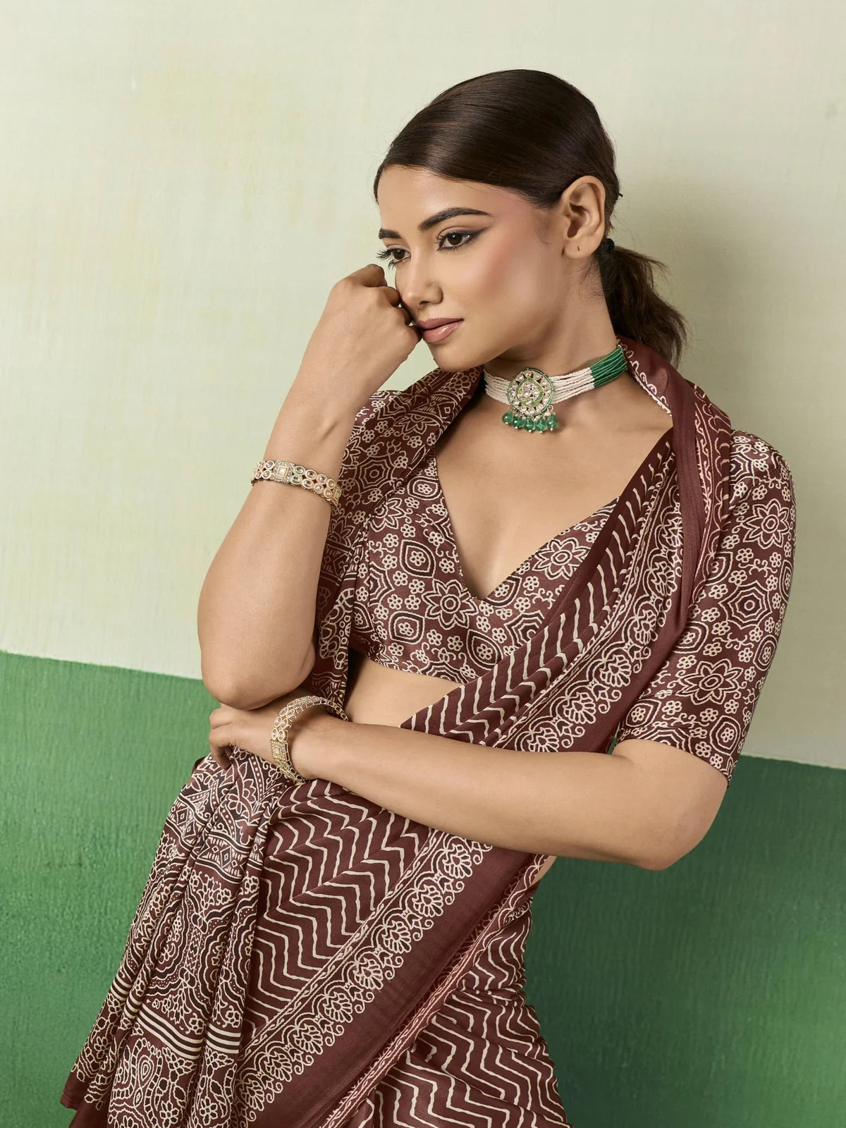 Tarani brown Ajrakh printed modal satin saree side pose with elegant drape and border detailing