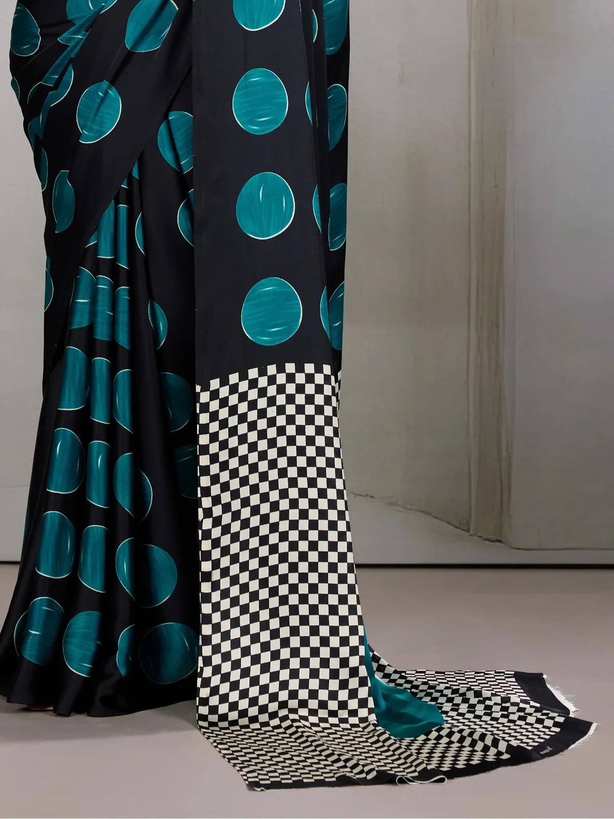 Tarani green saree pallu closeup with black and white checker design and teal contrast
