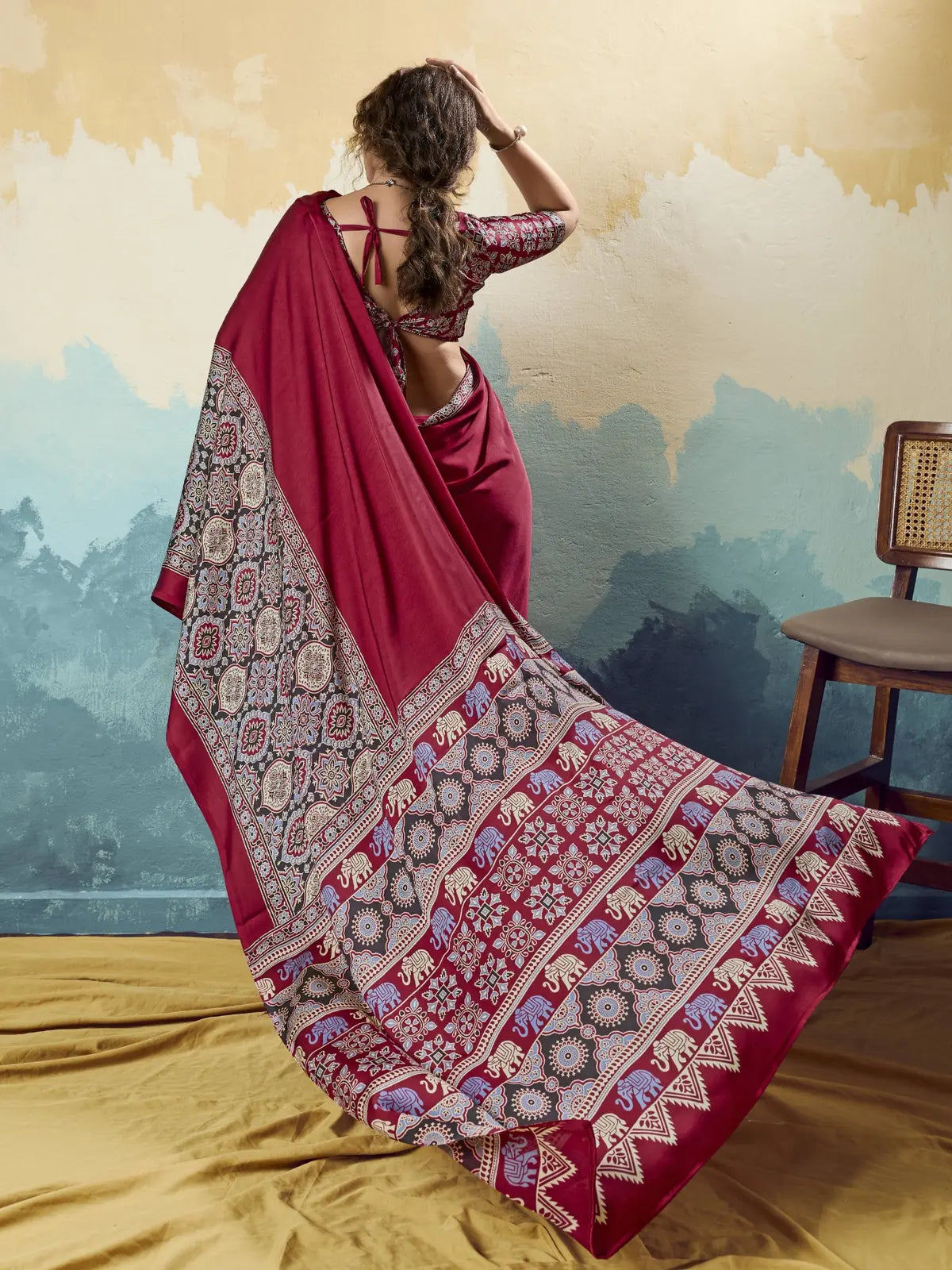 Tarani maroon modal satin Ajrakh print saree back view with flowing designer pallu