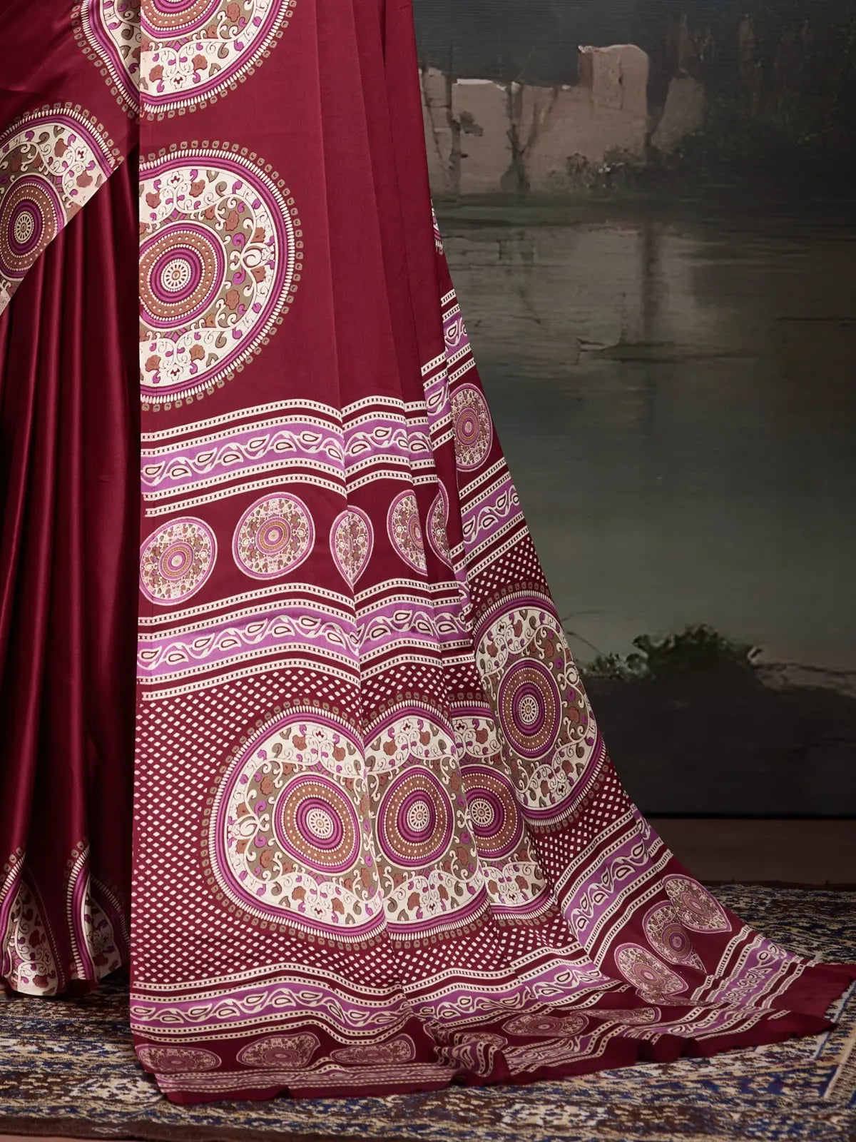 Tarani maroon saree pallu with Ajrakh style circular motifs and border design in detailed focus