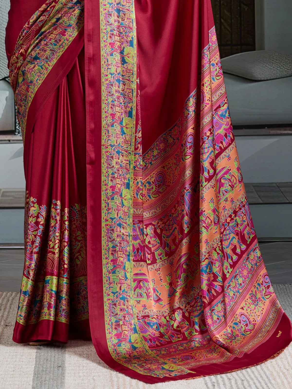 Tarani modal satin saree pallu view showcasing vibrant Ajrakh print in maroon tones