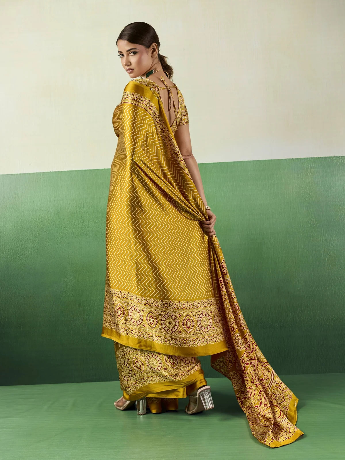 Tarani mustard Ajrakh print saree back view with stylish blouse pattern and flowing pallu