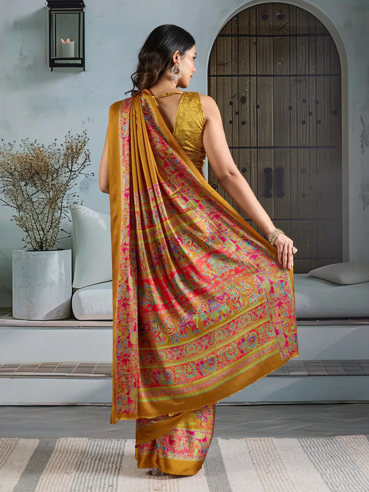 Back view of Tarani mustard modal satin saree highlighting elegant drape and pallu