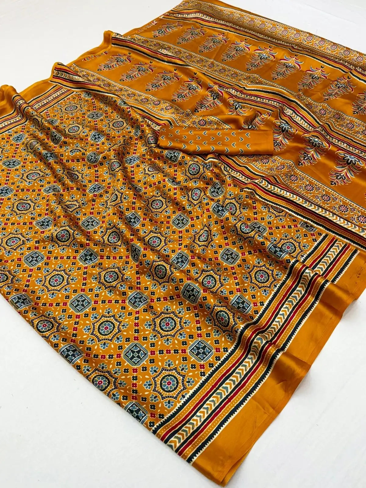 Tarani mustard modal satin Ajrakh print saree fabric flatlay with blouse piece