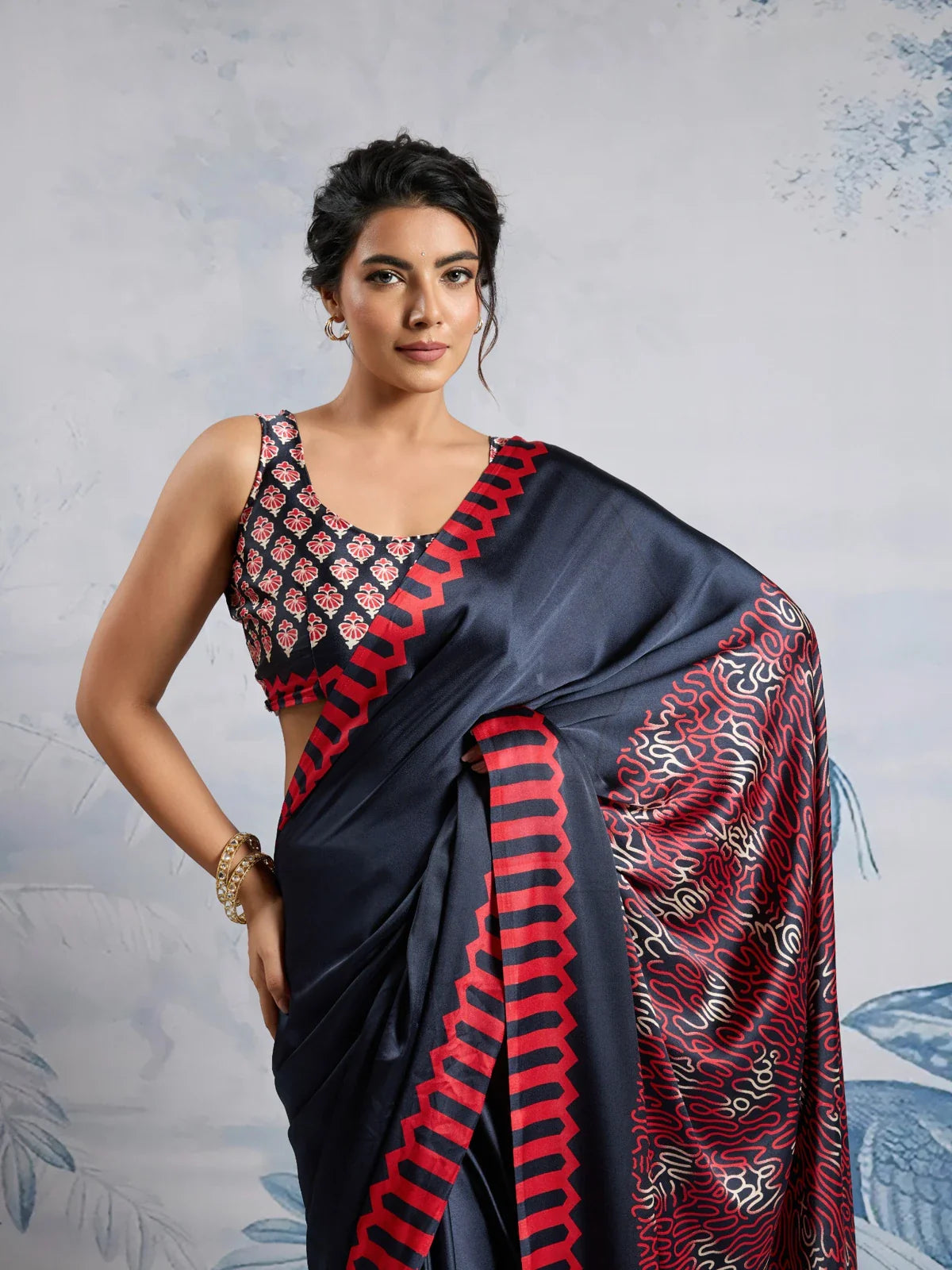 Tarani navy blue saree in modal satin fabric with red printed border and designer blouse close view
