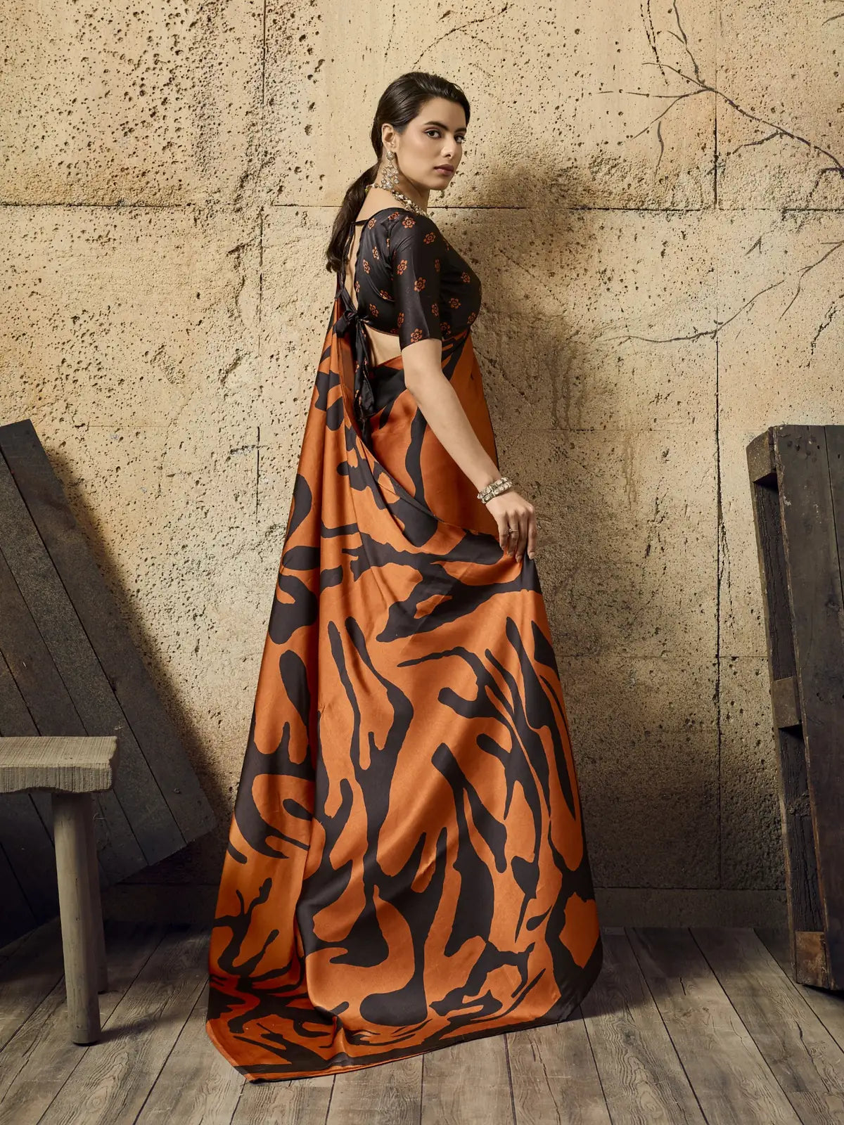 Tarani orange modal satin Ajrakh print saree back view with elegant drape