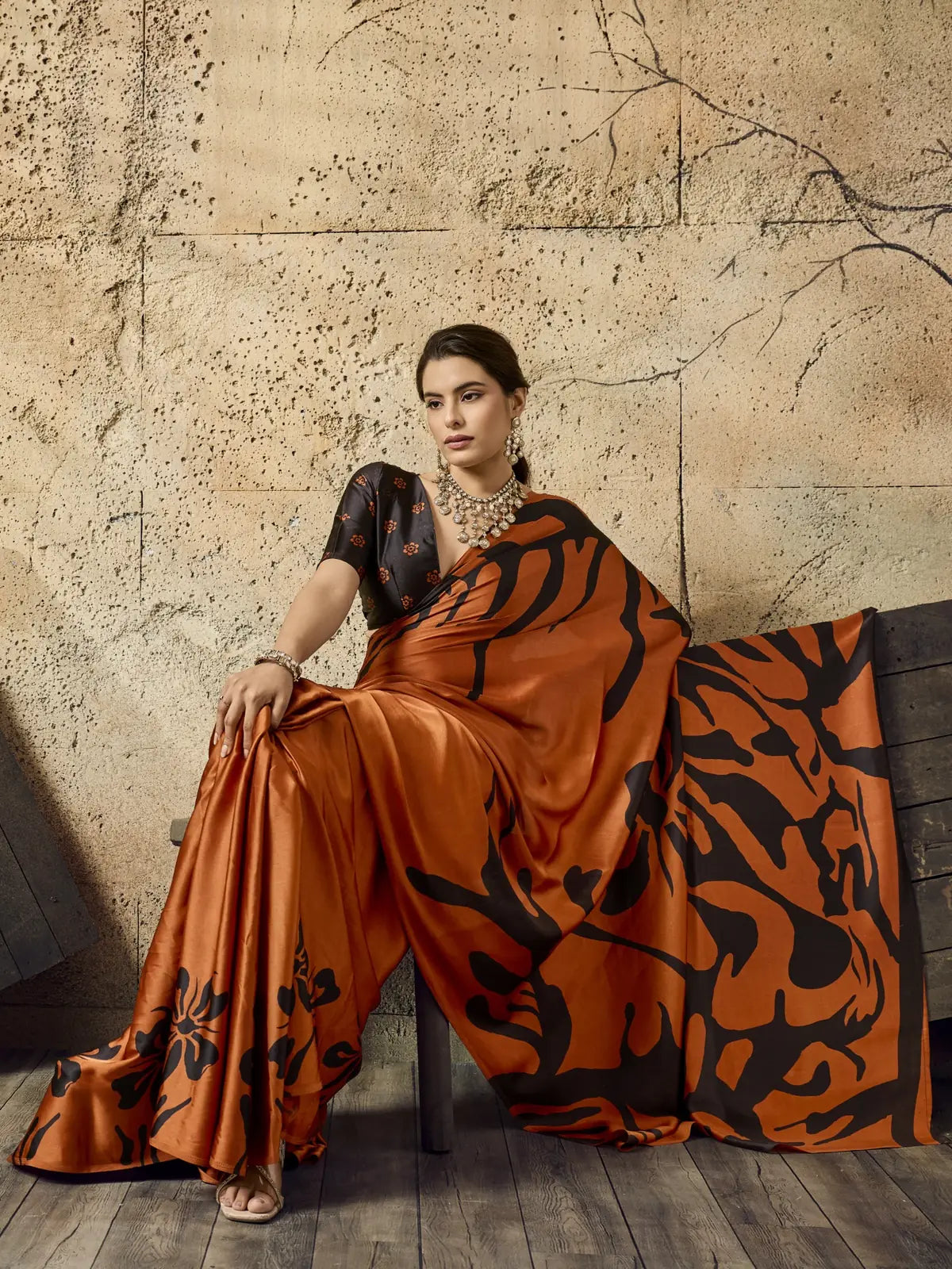 Tarani orange Ajrakh print modal satin saree with elegant flowing pallu view