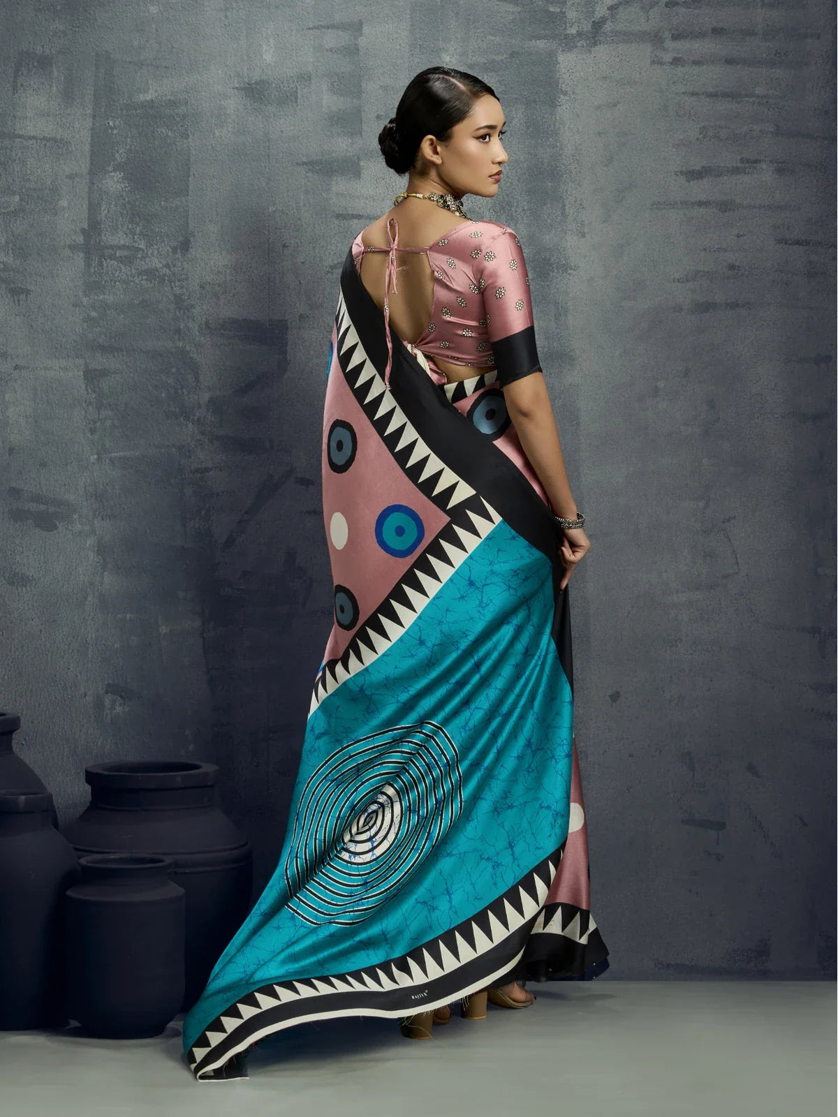 Tarani modal satin saree back view with teal pallu and striking graphic design in modern pattern