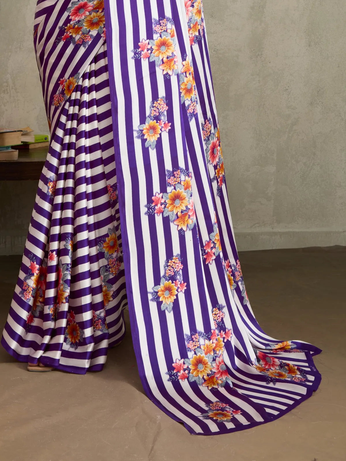 Tarani saree closeup showing purple striped body and multicolor floral print with premium satin shine