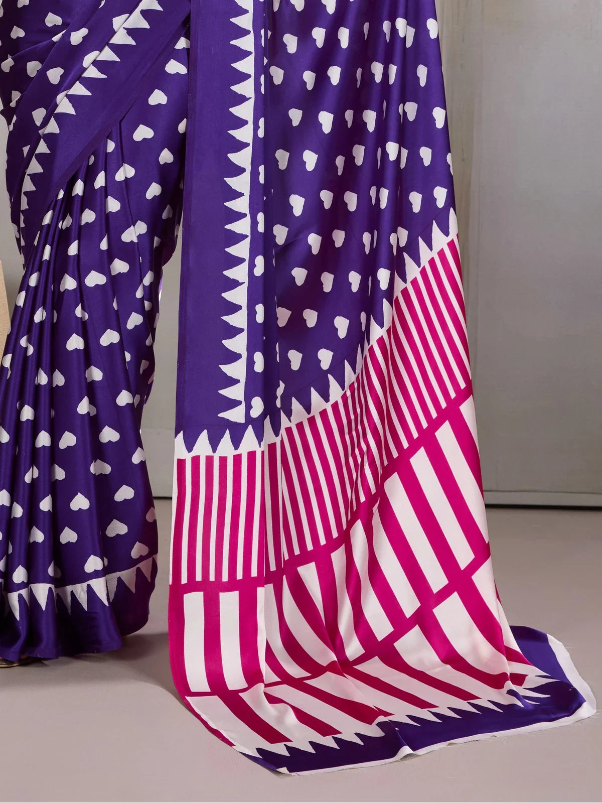 Tarani modal satin saree showing bold pink and white striped pallu with purple border in closeup view