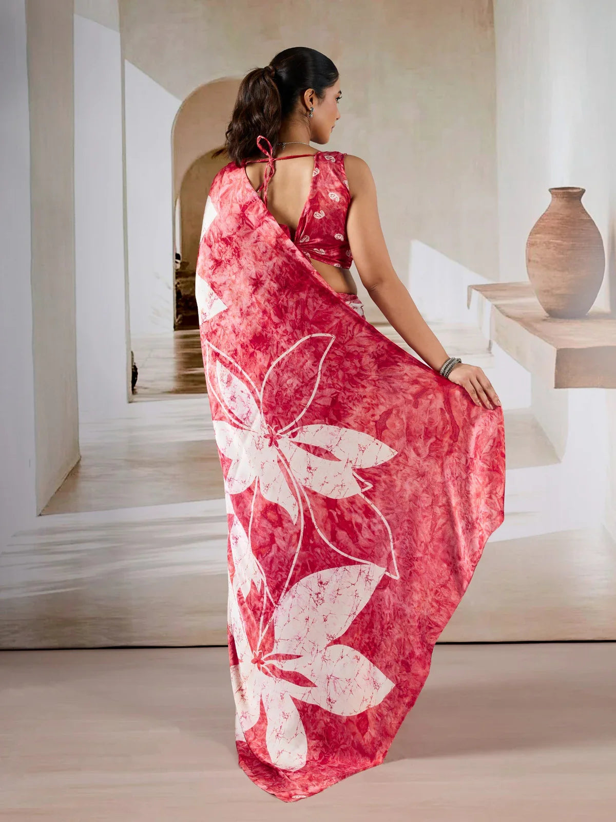 Tarani red modal satin saree back view with elegant blouse tie-up and floral pallu