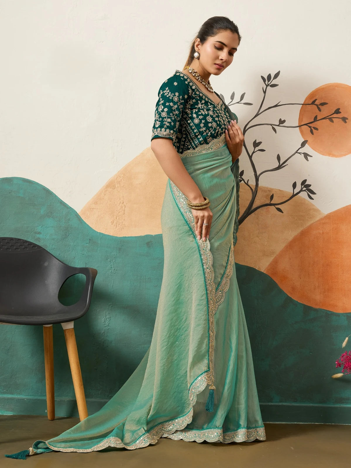 Tarani sea green wedding saree with designer border in elegant side pose