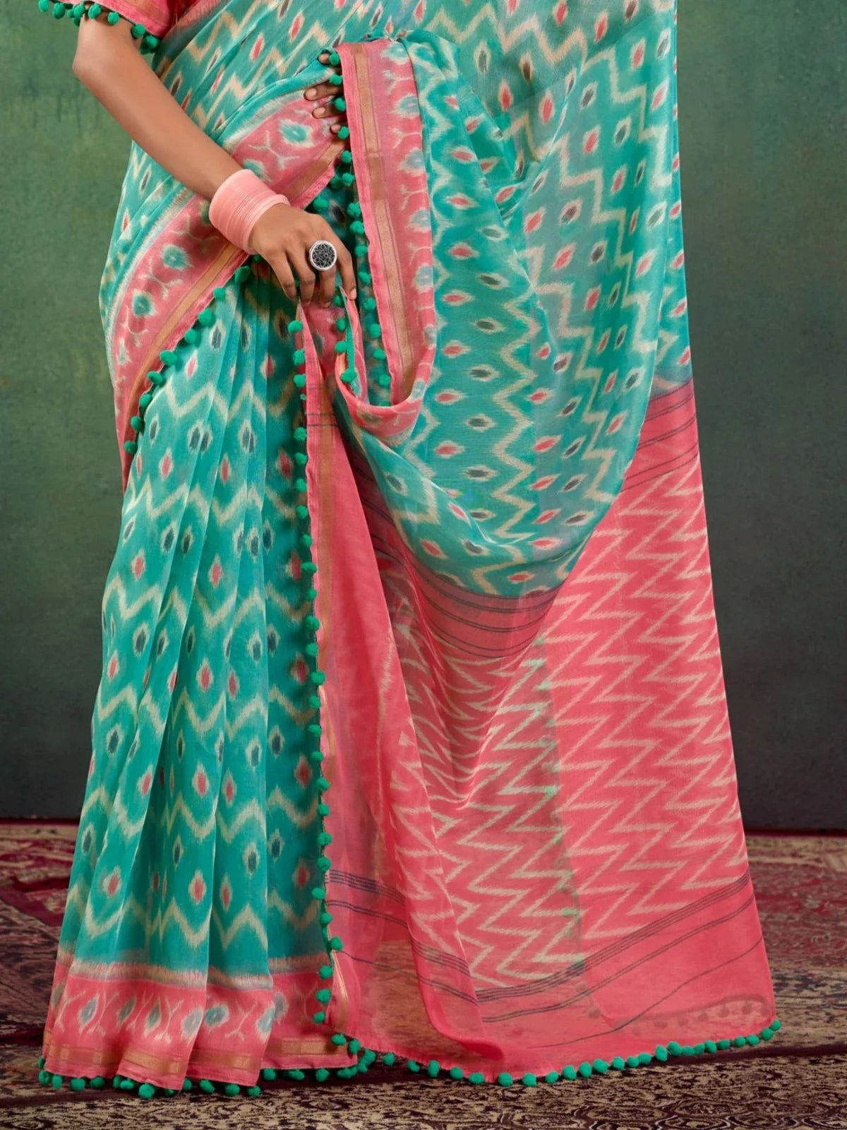 Tarani festive mul mul cotton saree pallu close-up with ikat pattern in green and pink