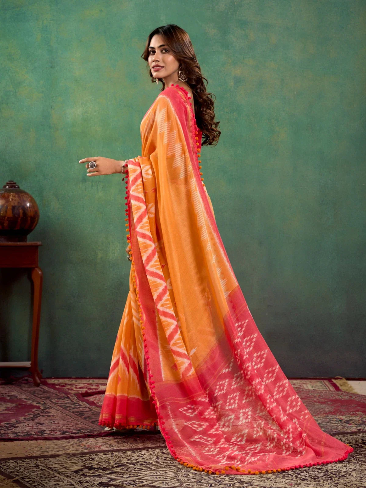 Tarani orange mul mul cotton saree side view showing elegant festive drape