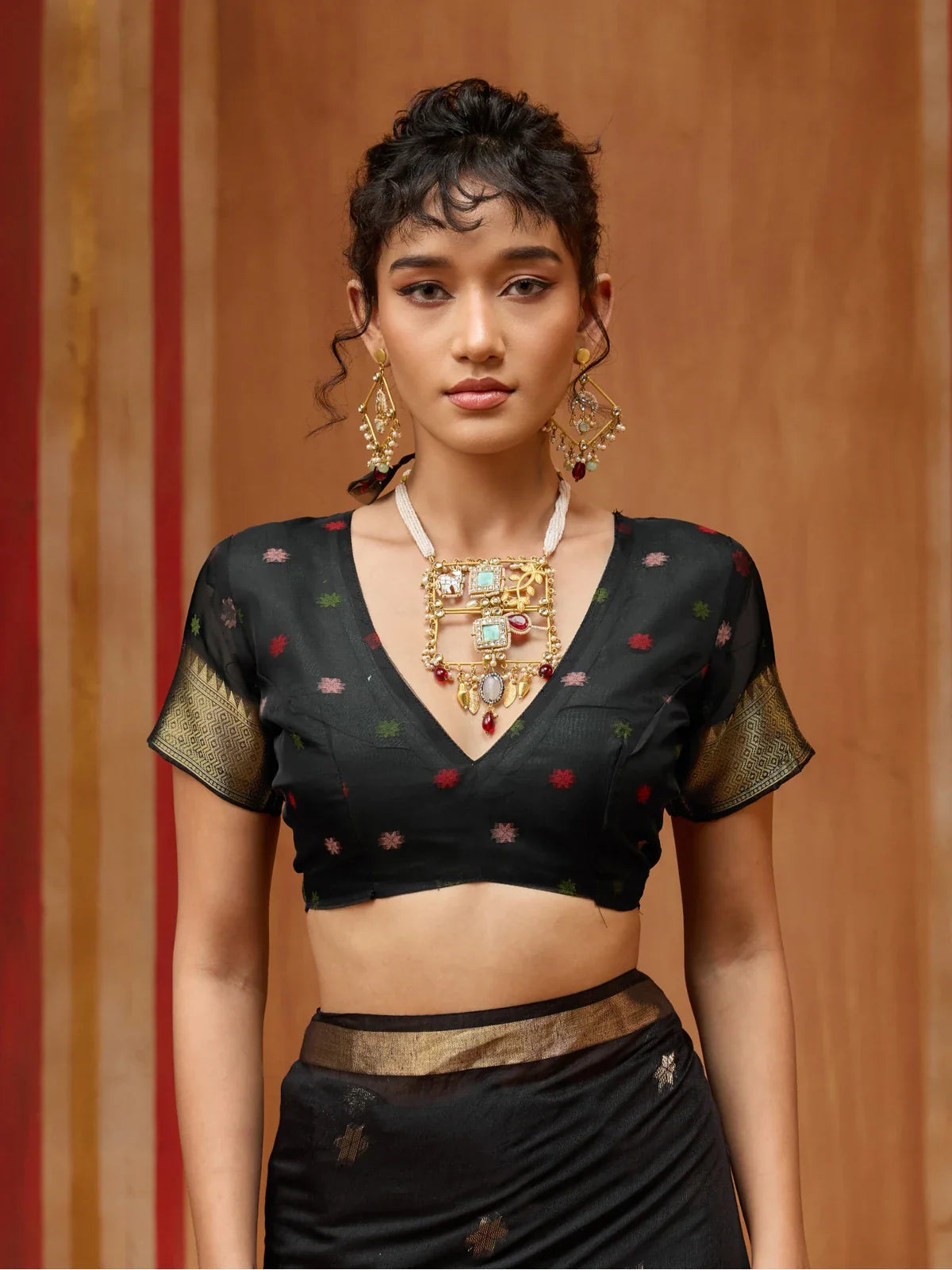 Tarani black handloom saree with woven gold details and matching blouse upper body view