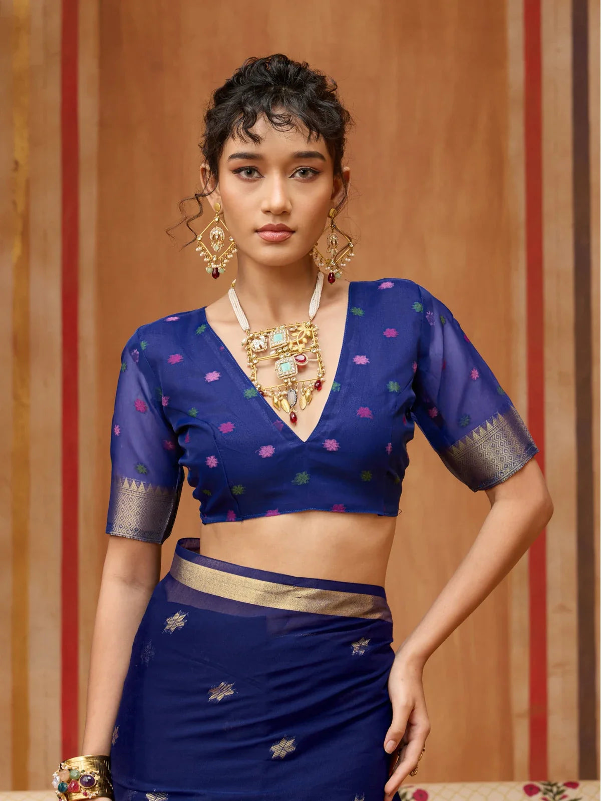 Tarani close-up of blue munga cotton blouse with golden sleeve detailing