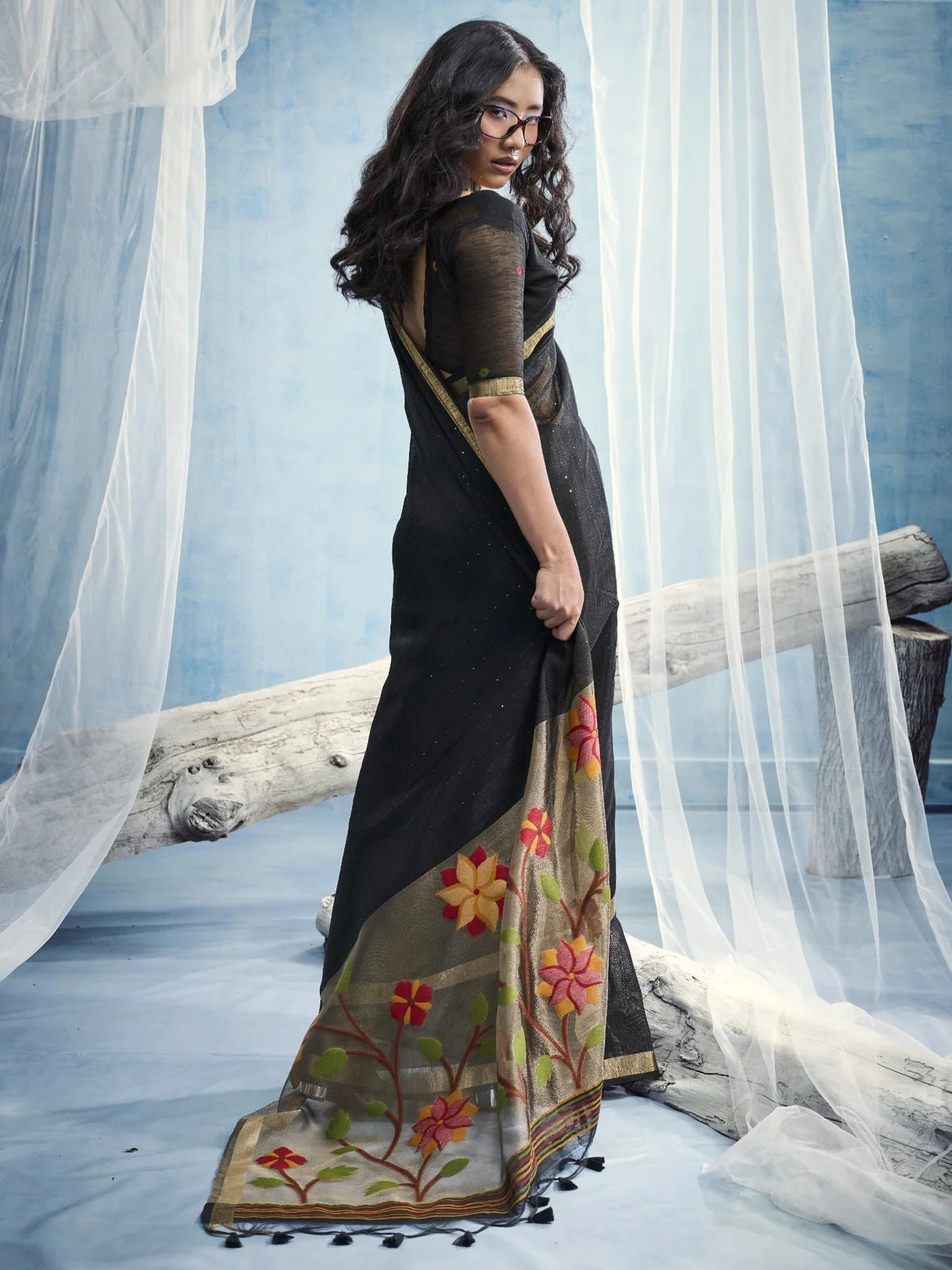 Tarani Samira black saree back view with floral tissue pallu and tassel detailing