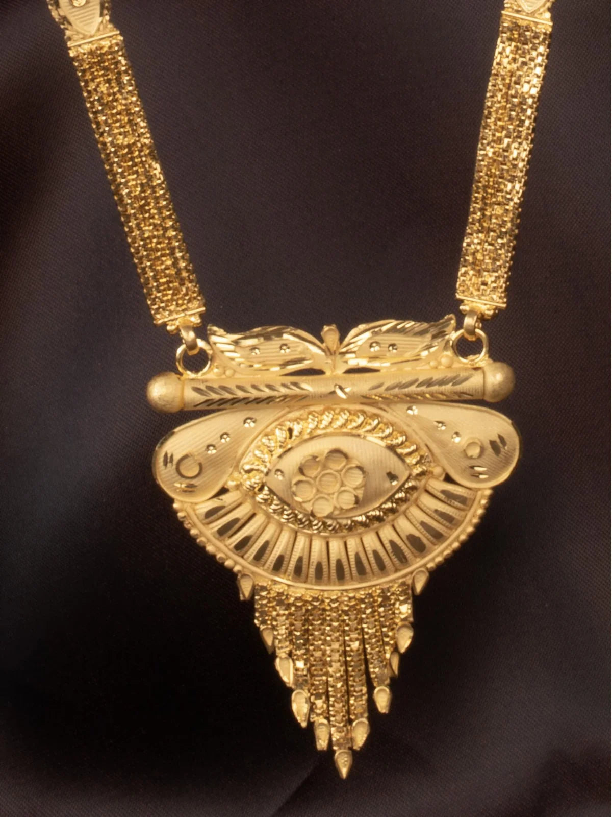 Tarani closeup view of gold plated necklace showing intricate design for festive wear