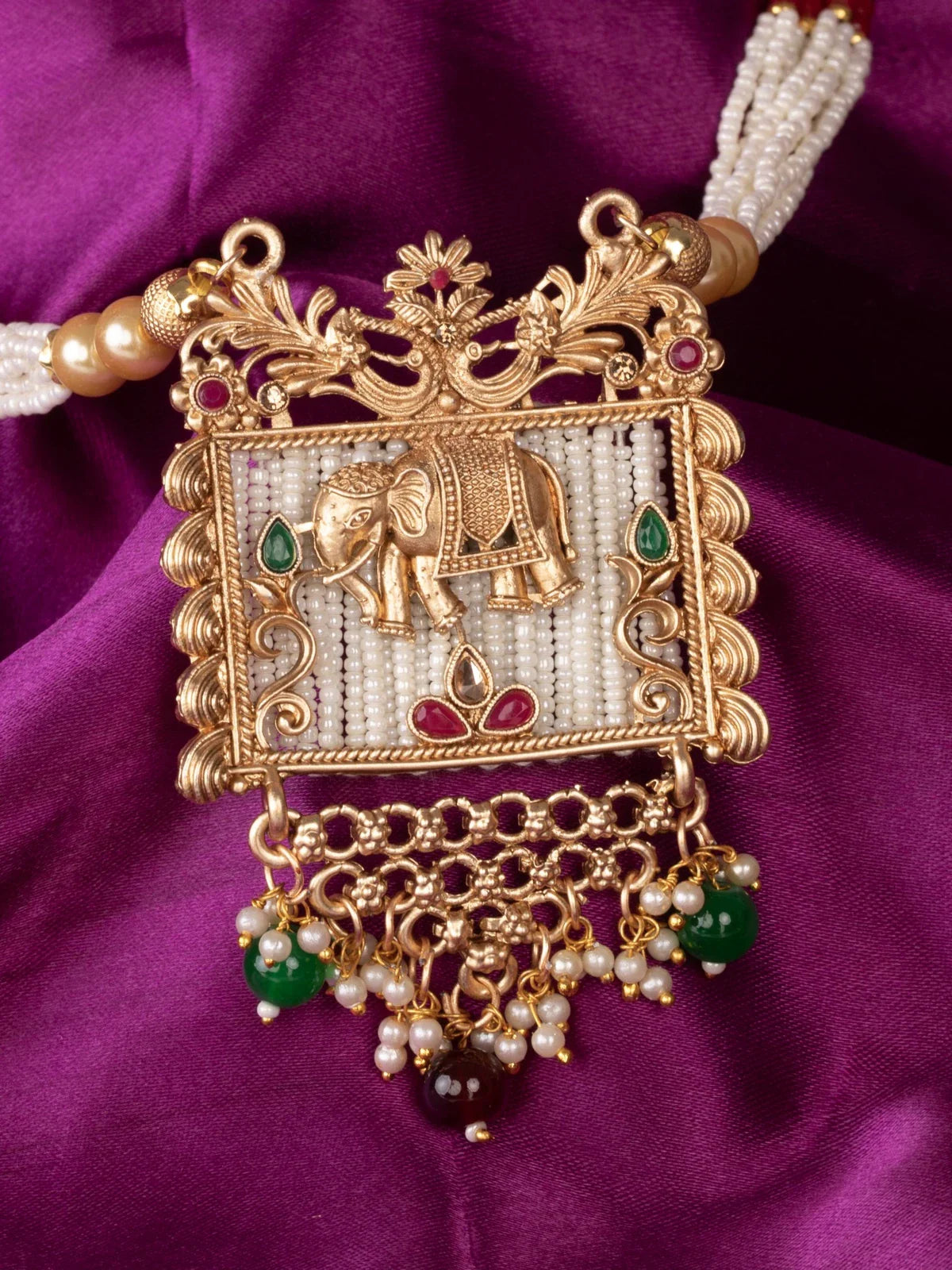 Tarani closeup view of gold plated elephant motif necklace with pearl beads for festive wear