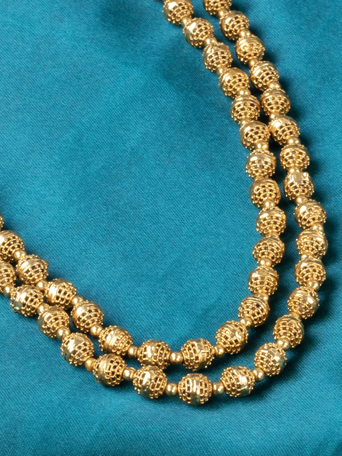 Tarani closeup view of gold plated necklace showing bead detailing