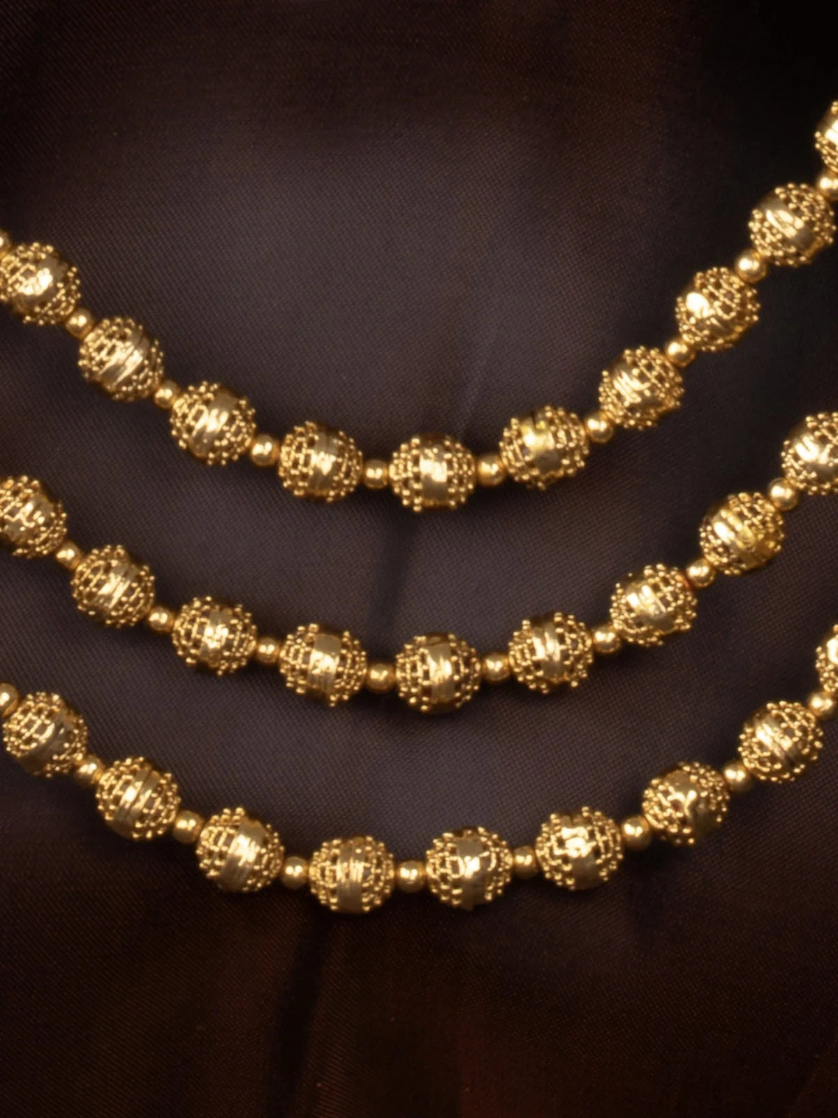 Tarani closeup view of gold plated beaded necklace set showing intricate detailing