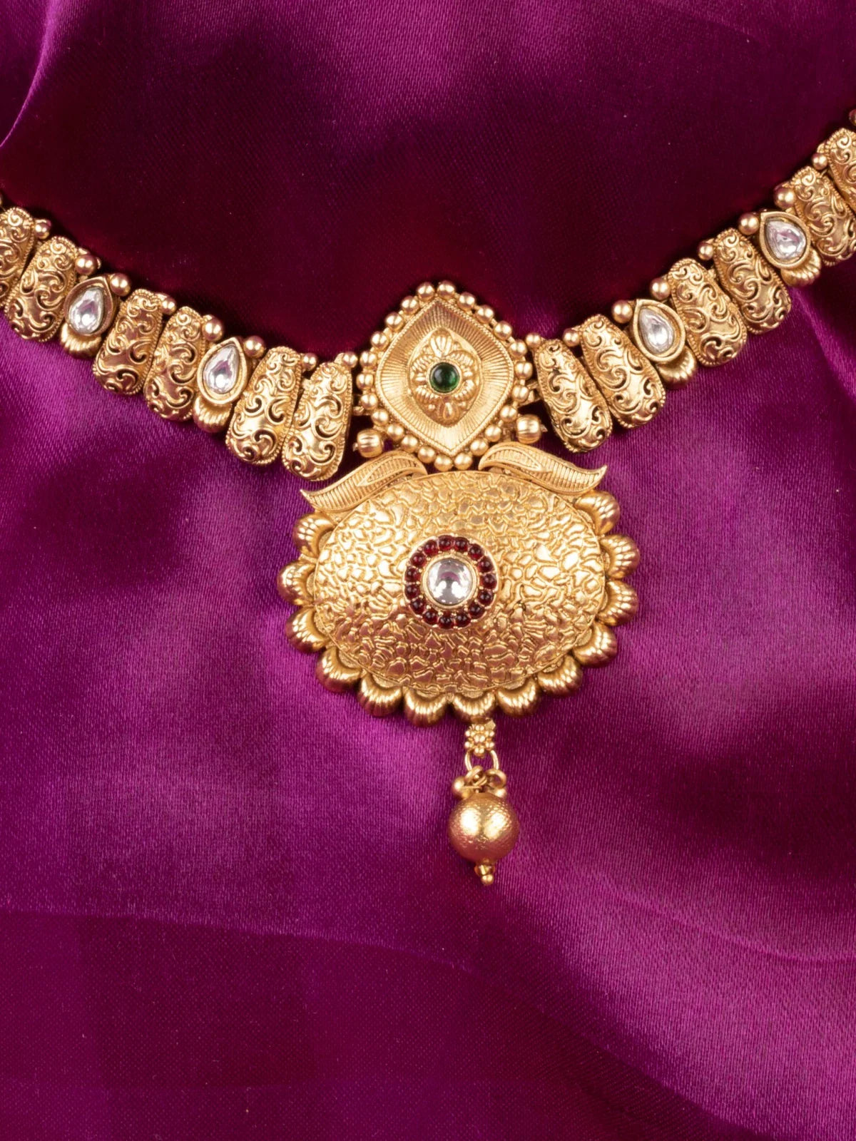 Tarani closeup view of gold plated antique necklace set showing detailed stone work