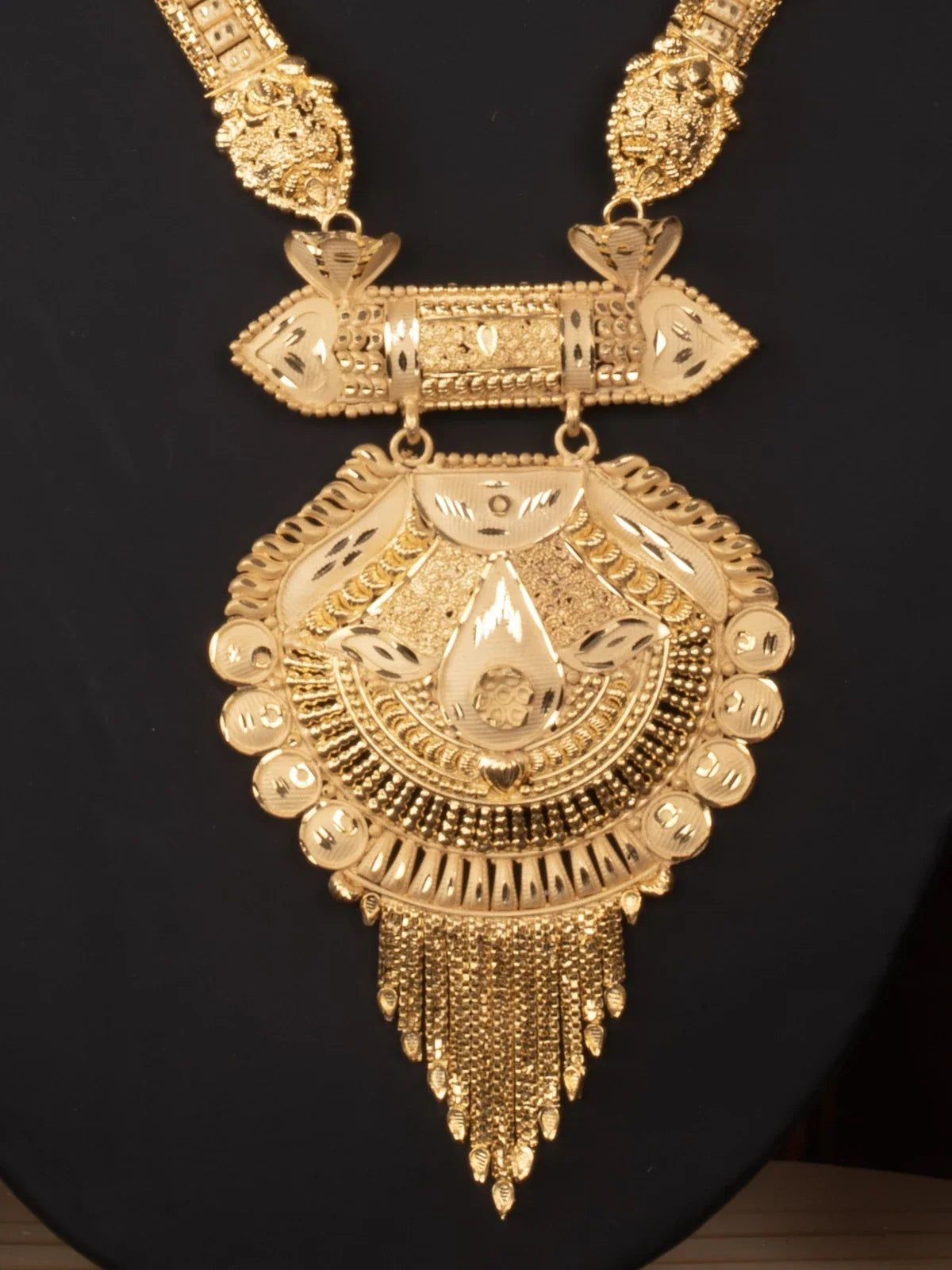 Tarani closeup view of gold plated necklace set showing intricate detailing