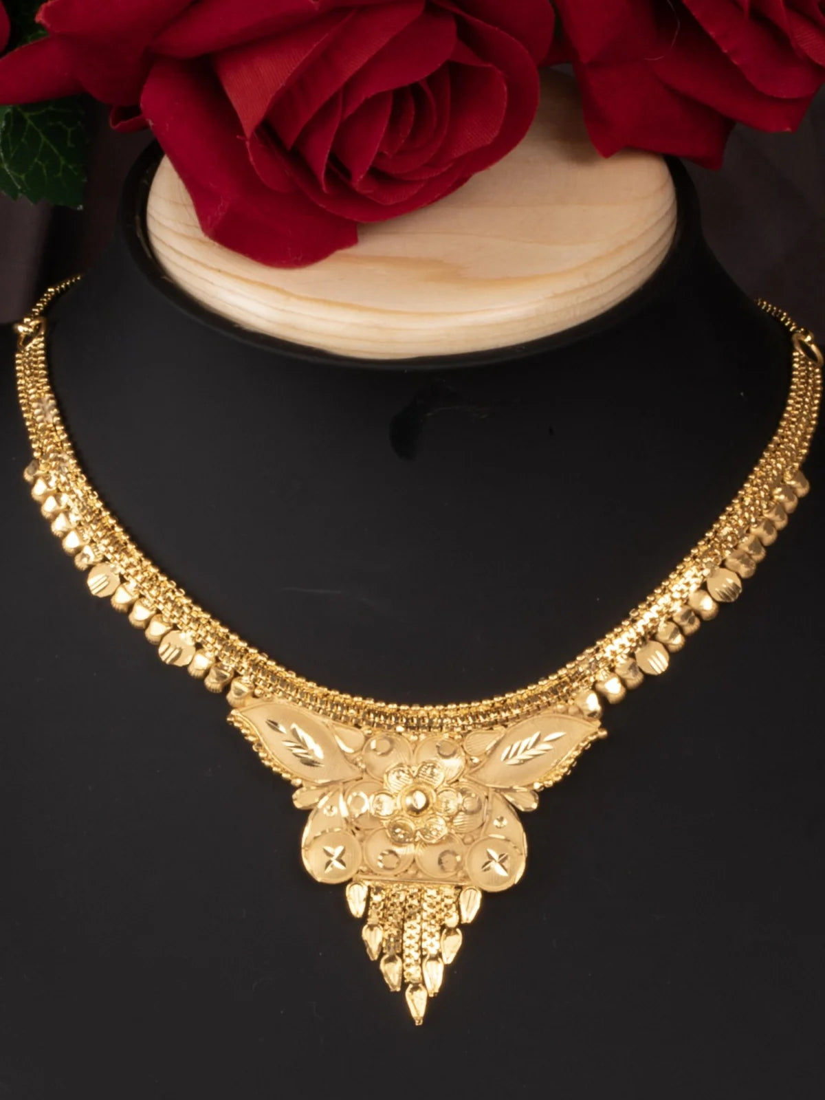Tarani closeup view of gold plated necklace set floral design for festive wear