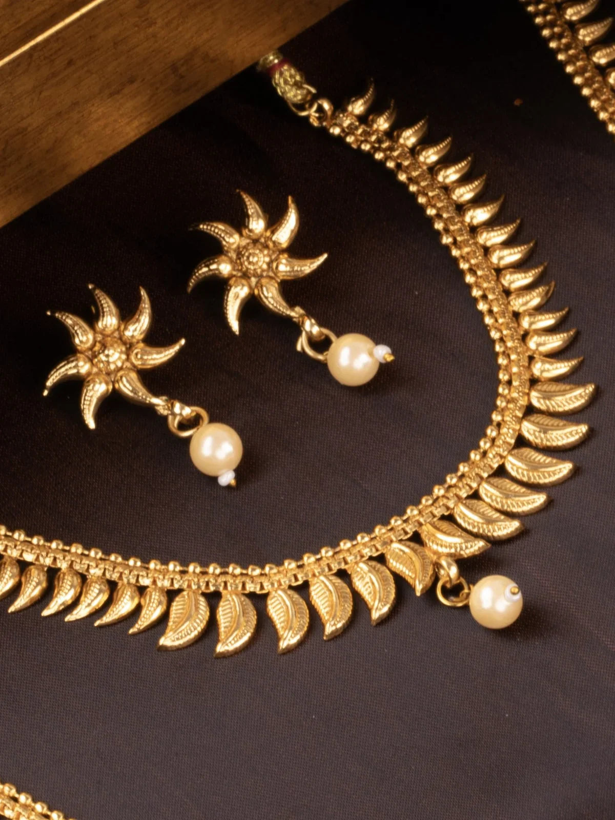 Tarani jewellery set view featuring gold plated necklace and earrings styled for weddings