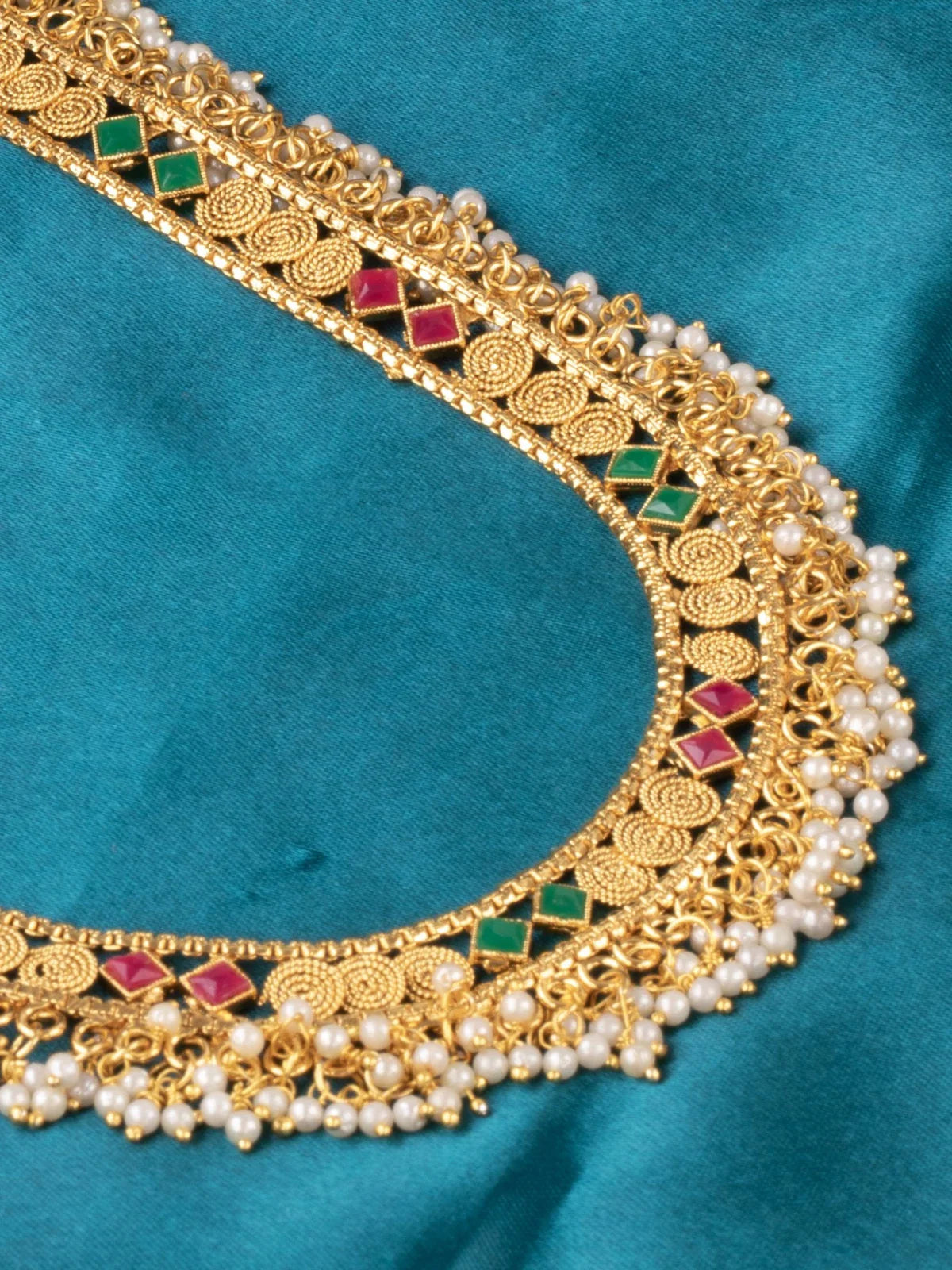 Tarani closeup view of gold plated necklace set with pearl bead work and antique detailing
