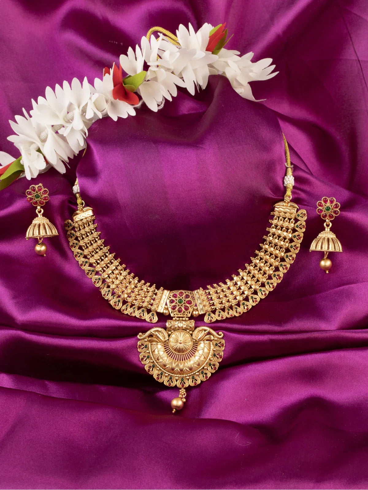 Tarani gold plated necklace set with red and green stones for weddings and festive occasions