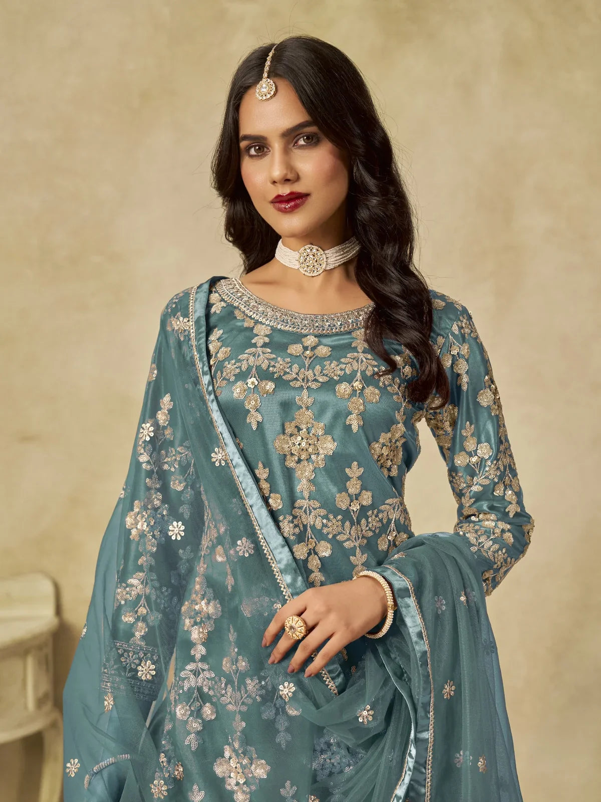 Tarani teal net sharara suit upper body view showing intricate neckline embroidery