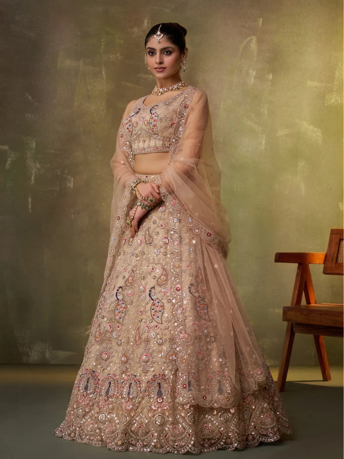 Tarani beige net lehenga front pose with heavy embroidery and dupatta styling