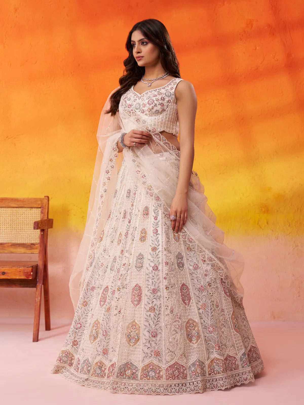 Tarani side pose showcasing net lehenga’s detailed embroidery and dupatta styling
