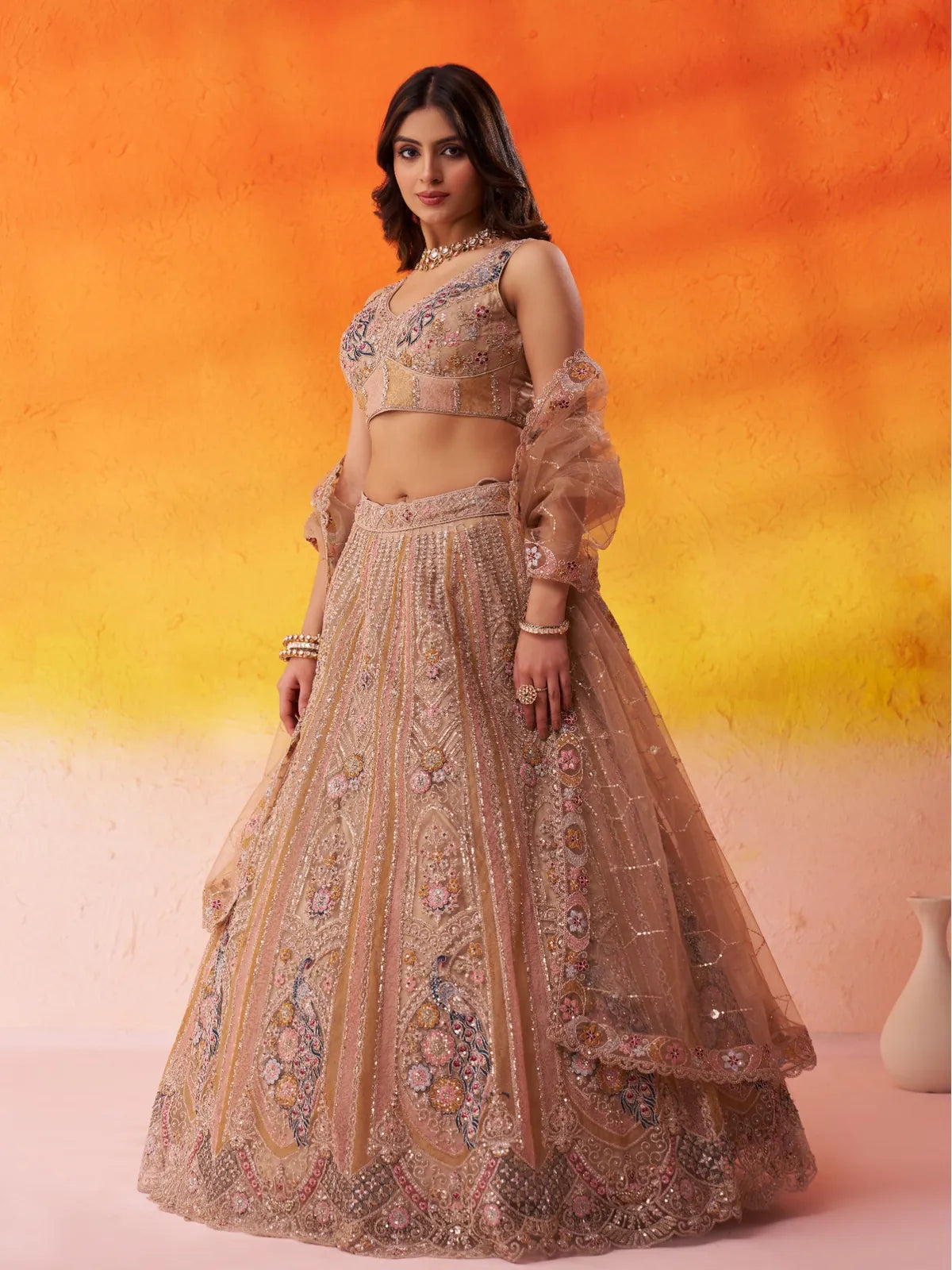 Tarani side profile of beige net lehenga with sequins work and soft dupatta fall