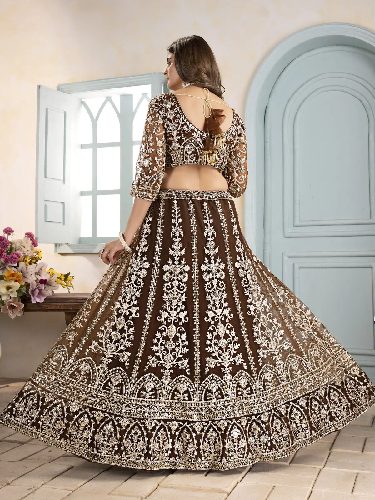 Tarani brown net lehenga back view showing blouse design and flair
