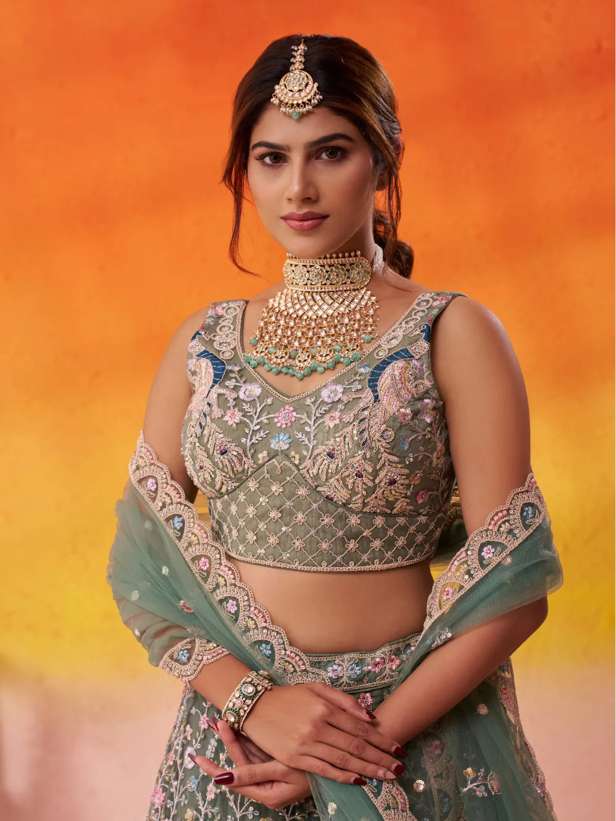 Upper body view of Tarani green net lehenga showing embroidered blouse and neckline
