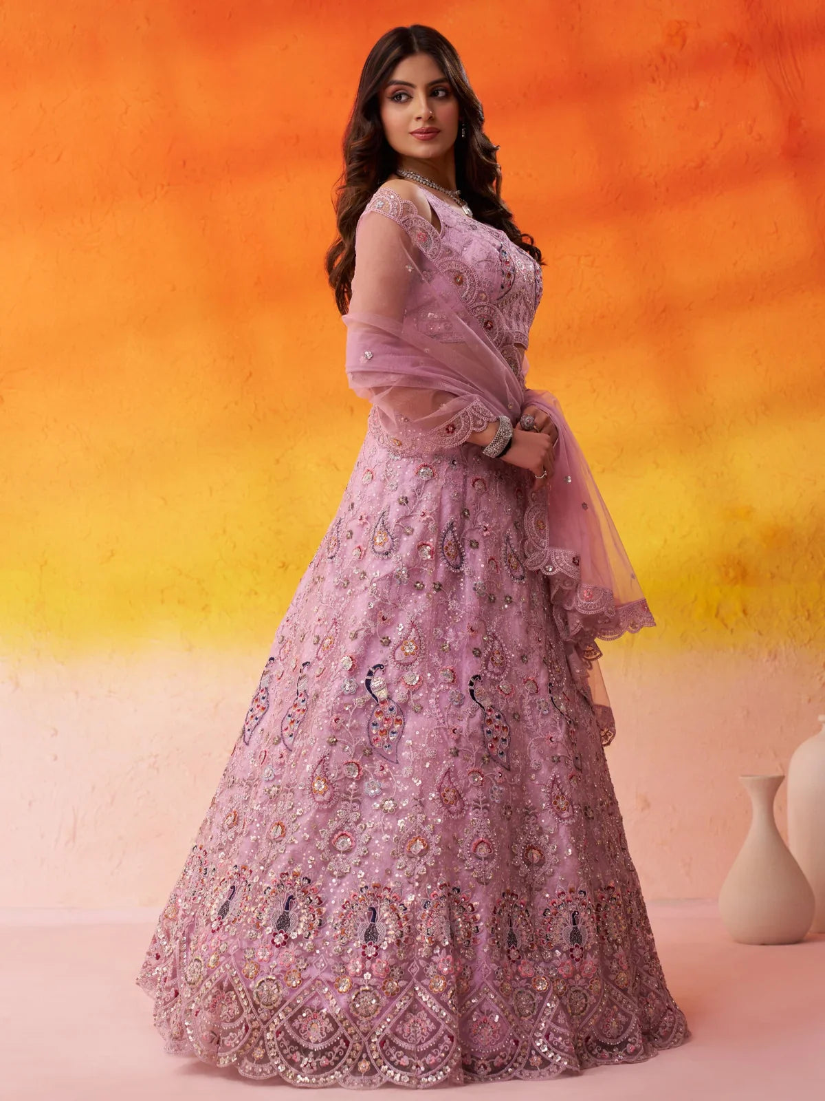 Tarani net lehenga side profile showing graceful drape and sequinned dupatta styling