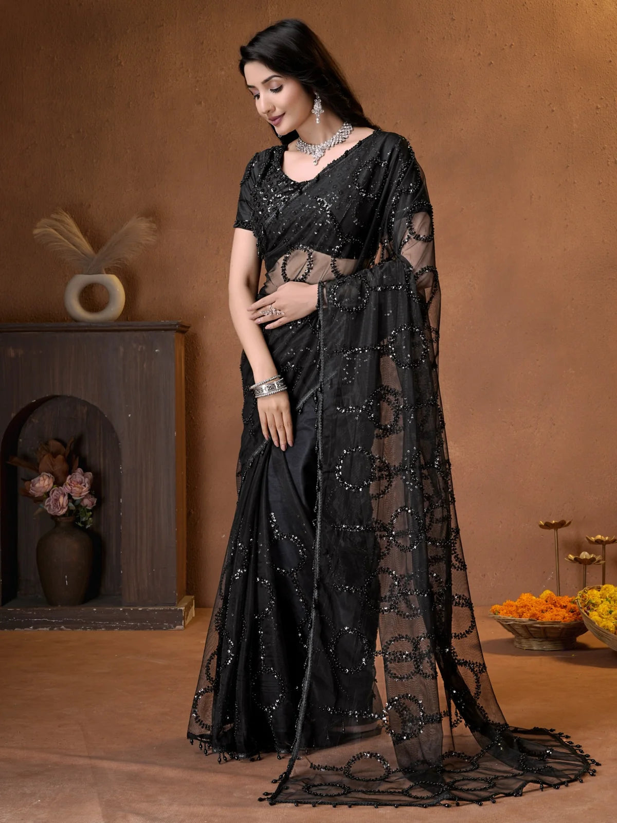 Tarani elegant black net saree side view with flowing embroidered pallu