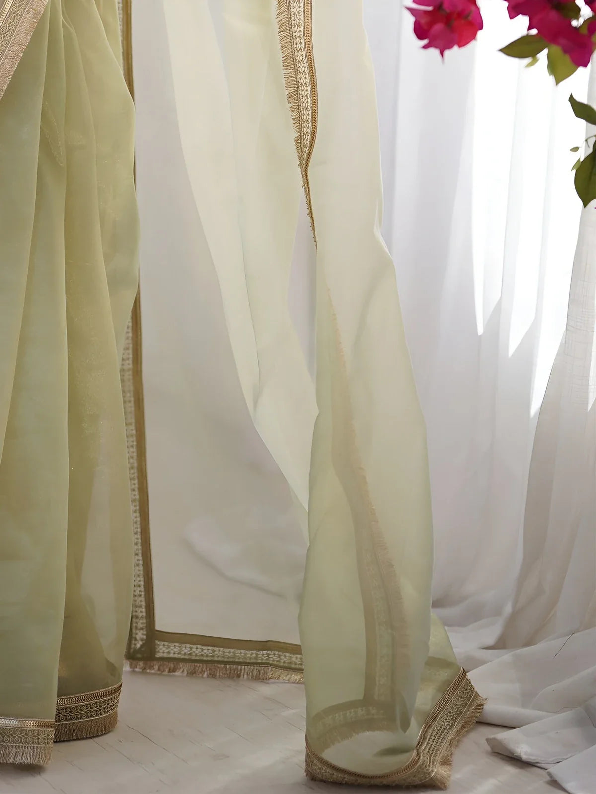 Tarani golden net saree pallu view showcasing large sequin codding lace and shimmer texture