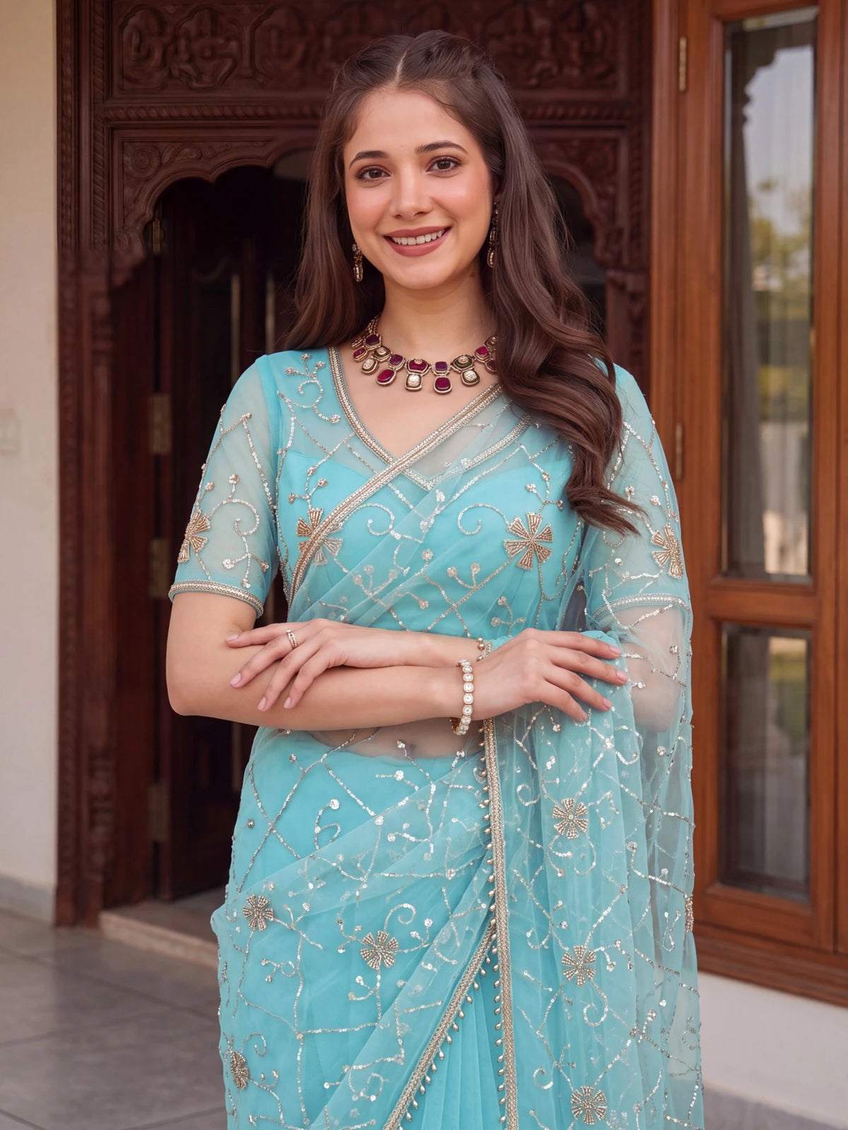 Tarani sky blue net saree upper body view with embroidered blouse and neckline