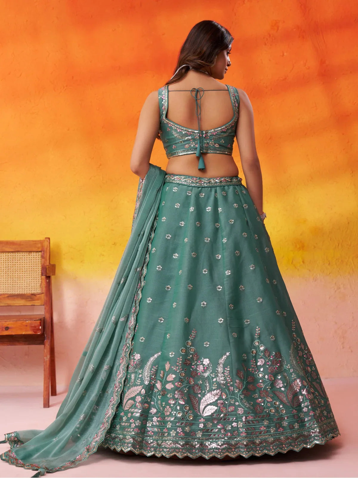 Tarani green lehenga back blouse design in organza with tie-up pattern and embroidered detail
