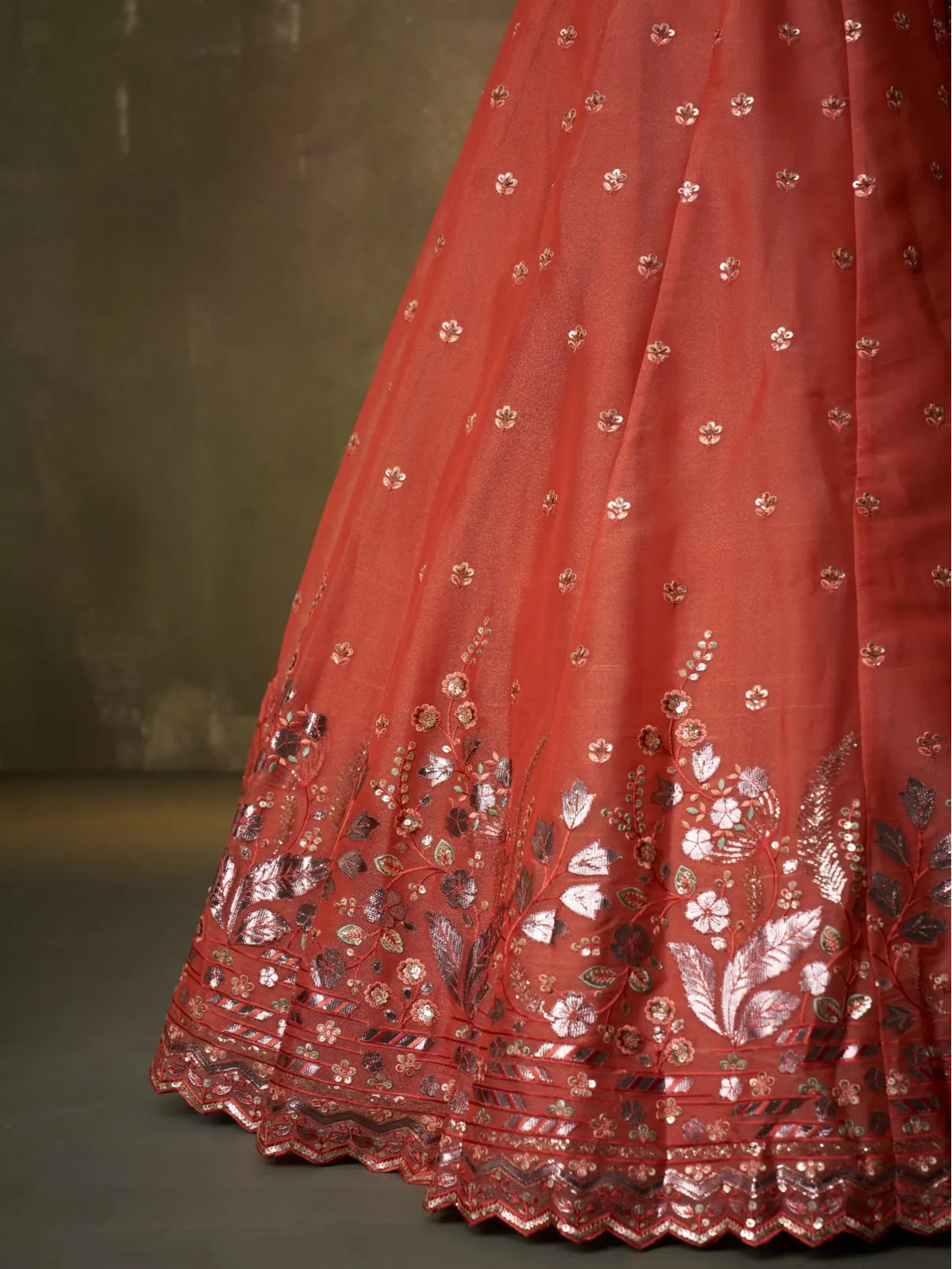 Tarani closeup of floral embroidery and shimmer detailing on orange lehenga for premium festive look