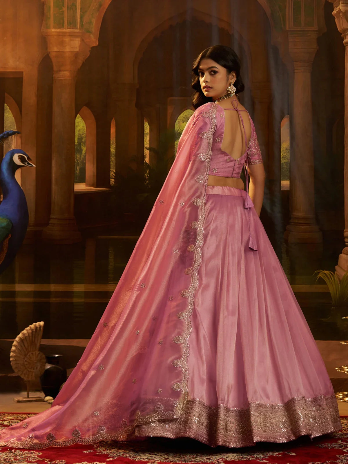 Back view of Tarani pink organza lehenga with deep-cut blouse and flowy silhouette