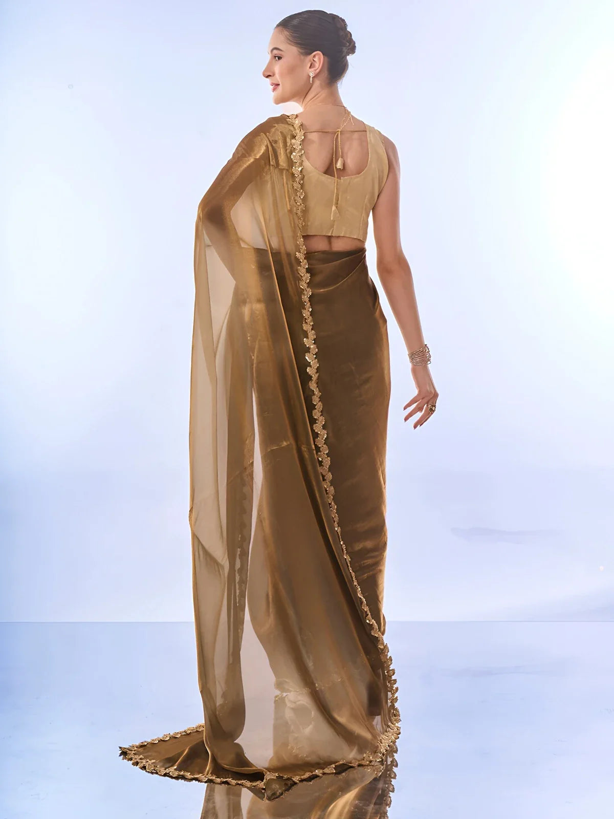 Back view of Tarani organza saree showcasing soft fabric drape and gold blouse design